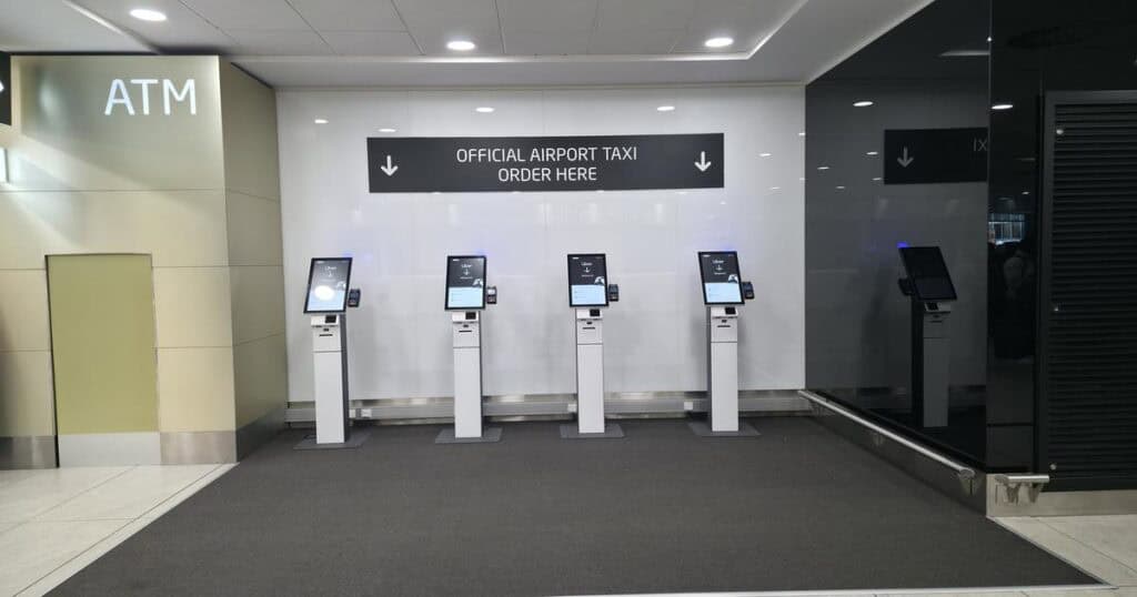 Official airport taxi order kiosks at Prague Airport for travelers