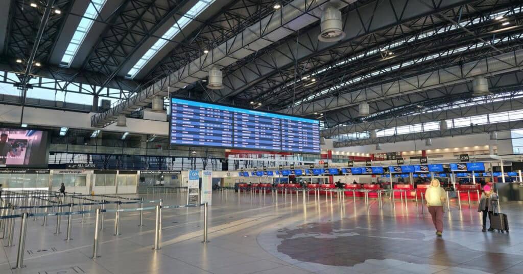 Check-in counters at Prague Airport for travelers heading to the city center