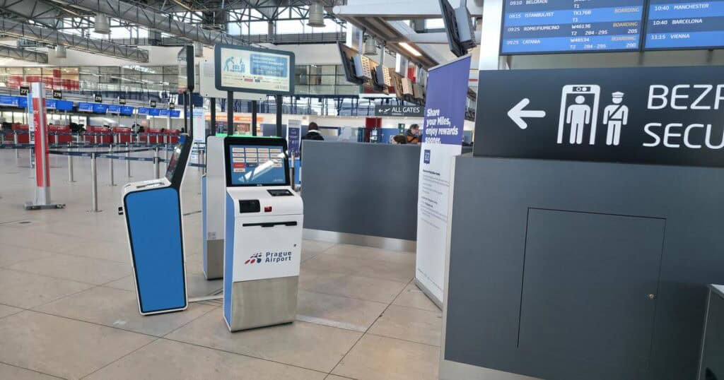 Check-in area at Prague Airport with clear signage.