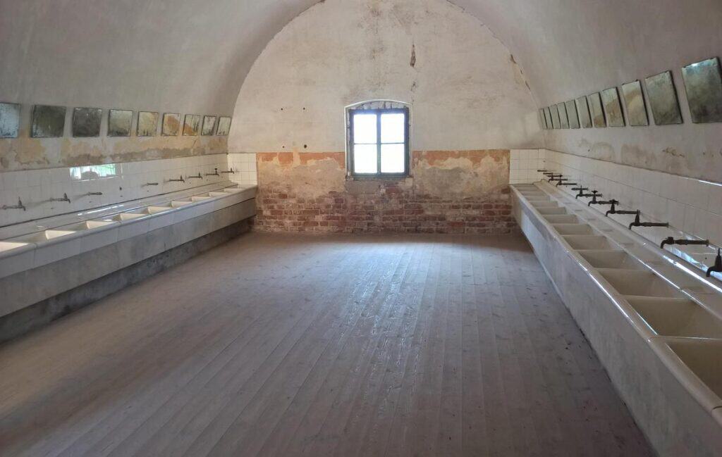 The bathroom area of Terezin Memorial Concentration Camp showing the historic facilities.