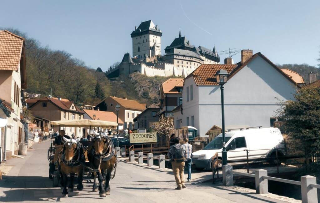 A view of Karlstejn Castle from Prague surrounded by beautiful landscape.